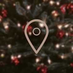 a close up of a christmas tree with a map pin on it's side