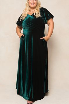 a woman wearing a green velvet dress