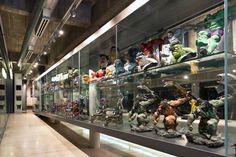 a display case filled with lots of different types of toy figurines on glass shelves