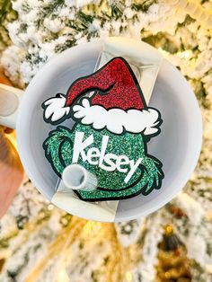 the kesey christmas ornament is on top of a white plate in front of a tree