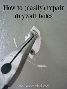 a close up of a pair of scissors with the words how to easily repair drywall holes