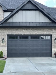 a house with a gray garage door in front of it