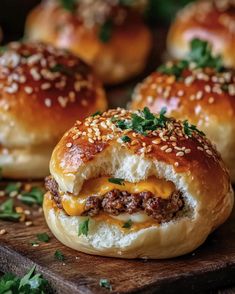 hamburger sliders with cheese and herbs on a cutting board, ready to be eaten