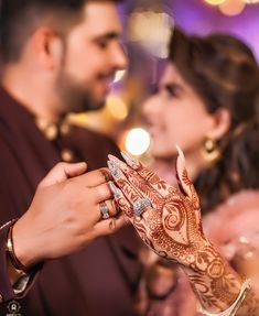 the bride and groom are holding their hands together