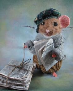 a mouse sitting on top of a pile of newspapers