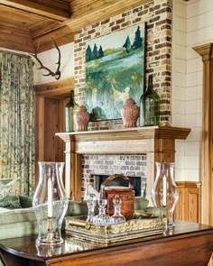 a living room filled with furniture and a fire place in front of a painting on the wall