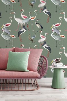 a living room with a pink couch and wallpaper that has flamingos on it