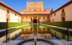 the courtyard of an old building with water in it and its reflection on the ground