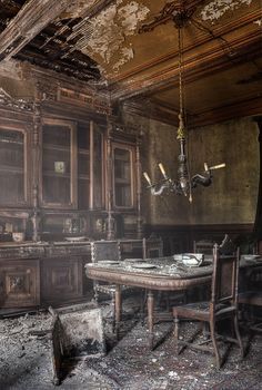 an old kitchen with wooden cabinets and a chandelier