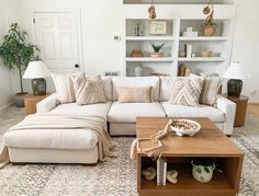 a living room filled with lots of furniture and decor on top of a white rug