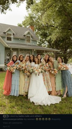 a group of women standing in front of a house