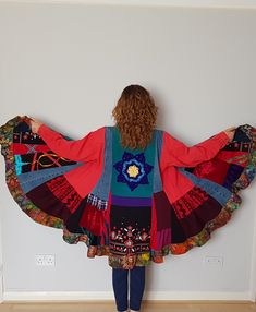 a woman standing in front of a white wall