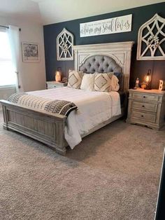 a bedroom with a large bed and two nightstands on either side of the bed