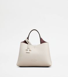 Bag in soft exposed grain leather, with Tod's logo stamped on the front, flat handle and removable shoulder strap. The interior comes with 2 compartments separated by a central zipped pocket. An elegant creation enhanced by distinctive iconic detailing, such as the metal T Timeless pendant and T-stitching. Off White Bag, Tods Bag, Grey Bag, Boston Bag, Timeless Accessories, Logo Stamp, Handbags For Women, Leather Items, Leather Mini