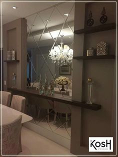 an image of a dining room with a mirror on the wall