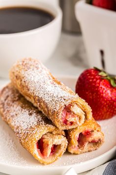 two pastries on a plate with strawberries and coffee