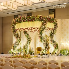 a wedding stage decorated with flowers and candles