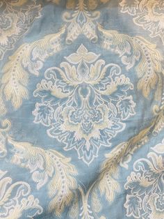 the blue and gold fabric has an intricate design on it