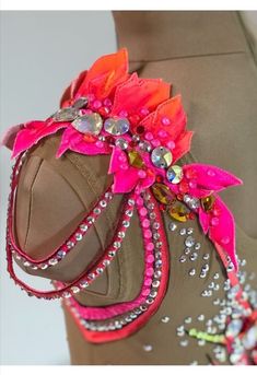 a mannequin headdress with pink, orange and silver beads on it