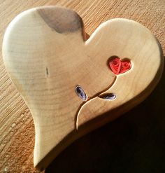 a wooden heart with two hearts on it