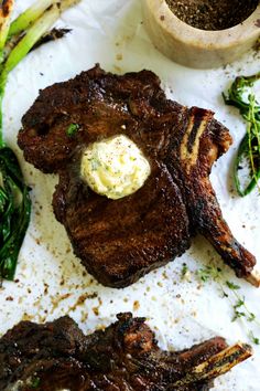 steak and asparagus on a white plate with a small bowl of ranch dressing