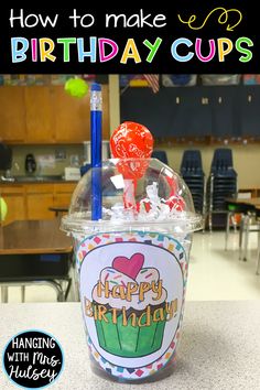 a birthday cup with candy and lollipops in it