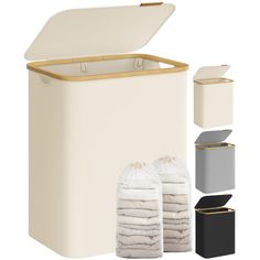 a white trash can with two bags and three boxes next to it