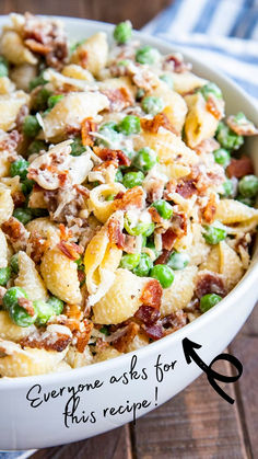 a white bowl filled with pasta and peas