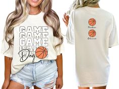 a woman wearing a white shirt with basketballs on it and the same t - shirt