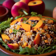 a plate filled with rice and vegetables next to peaches