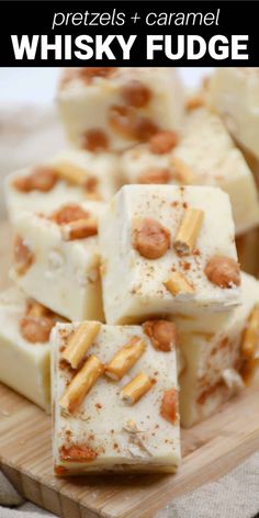 several pieces of white chocolate with nuts on top and the words, pretzels + caramel whisky fudge