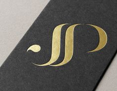 a black and gold business card with the letter j on it's front cover