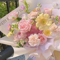 a bouquet of flowers sitting on top of a sign