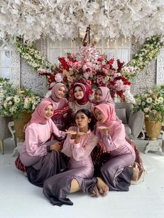 a group of women in hijabs pose for a photo