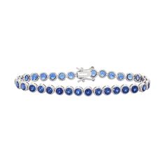 "Lab-created sapphire gemstones give this sterling silver tennis bracelet alluring appeal.BRACELET DETAILS Length: 7.25 in. Clasp: box Metal: rhodium-plated sterling silver STONE DETAILS Stone type: lab-created sapphire Total weight: 8 1/2 ct. Shape: round Setting: bezel  Size: 7.25"". Color: Blue. Gender: female. Age Group: adult." Silver Sapphire Tennis Bracelet With Brilliant Cut, Sapphire Tennis Bracelet Fine Jewelry With Prong Setting, Blue Tennis Bracelet With Prong Setting For Formal Occasions, White Gold Sapphire Gemstone Tennis Bracelet, Sapphire Tennis Bracelet With 17 Jewels, Blue Round Tennis Bracelet With Prong Setting, Silver Sapphire Tennis Bracelet, Blue Tennis Bracelet With Prong Setting, Sapphire Brilliant Cut Tennis Bracelet