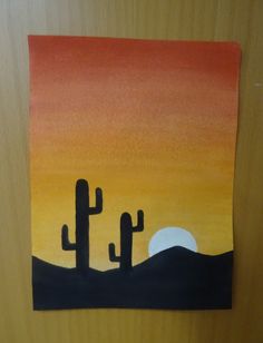 a painting on the wall of a bathroom with cactus and sunset in the background at night