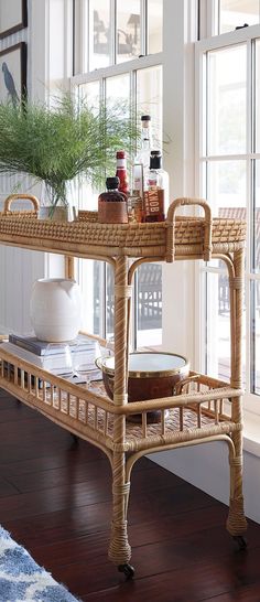 a wicker serving cart in front of a window