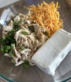 a glass plate topped with cheese, meat and veggies