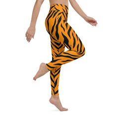 Unleash Your Wild SideIntroducing the Tiger Print Yoga Leggings from Elysian Loom, designed to take your workouts to the next level. With a vibrant orange and black tiger pattern, these leggings not only showcase your fierce side but also offer top-notch comfort and performance. Performance Meets StyleThese leggings are engineered with a raised waistband for added support and a flattering fit. The four-way stretch fabric allows for unrestricted movement, making them ideal for yoga, running, or a Orange Athleisure Yoga Pants For Gym, Orange Compression Activewear For Yoga, Sporty Orange Activewear For Pilates, Sporty Orange Yoga Leggings, Sporty Orange Leggings For Yoga, Casual Orange Leggings For Yoga, Orange Athleisure Yoga Pants For Sports, Orange Athleisure Yoga Leggings, Orange Athleisure Leggings For Yoga