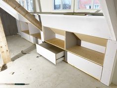 an unfinished room with shelves and drawers under construction