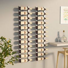 there is a wine rack with many bottles on it in the wall next to a table