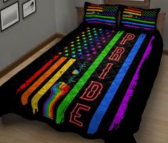 a bed covered in a black bedspread with an american flag design on it