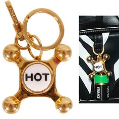 an item is shown with the word hot on it and a gold keychain