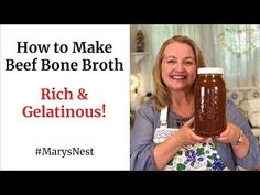 a woman holding a jar of homemade beef bone broth