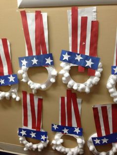 patriotic wreaths made out of toilet paper and pom poms are hanging on the wall