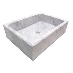 a white marble sink with a square bowl in the middle and a drain on the side