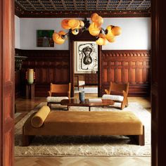 a living room filled with furniture and wooden paneling