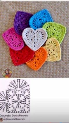 several crocheted hearts are arranged in different colors