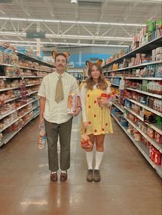 a man and woman are standing in the aisle of a grocery store, holding food