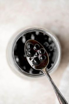 a spoon filled with liquid sitting on top of a table